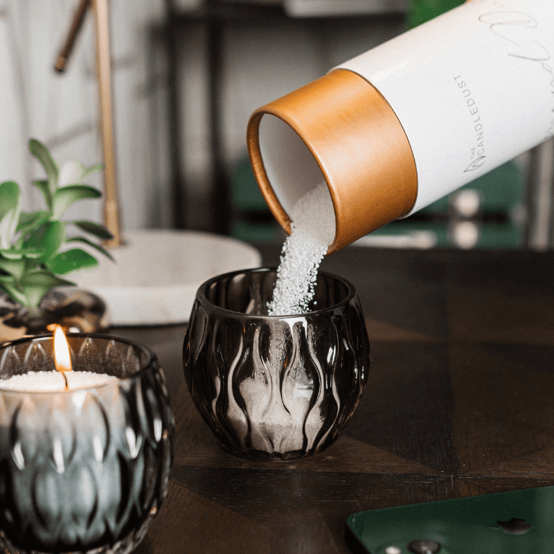 Lifestyle: lit Breeze scented powdered candle in a large container