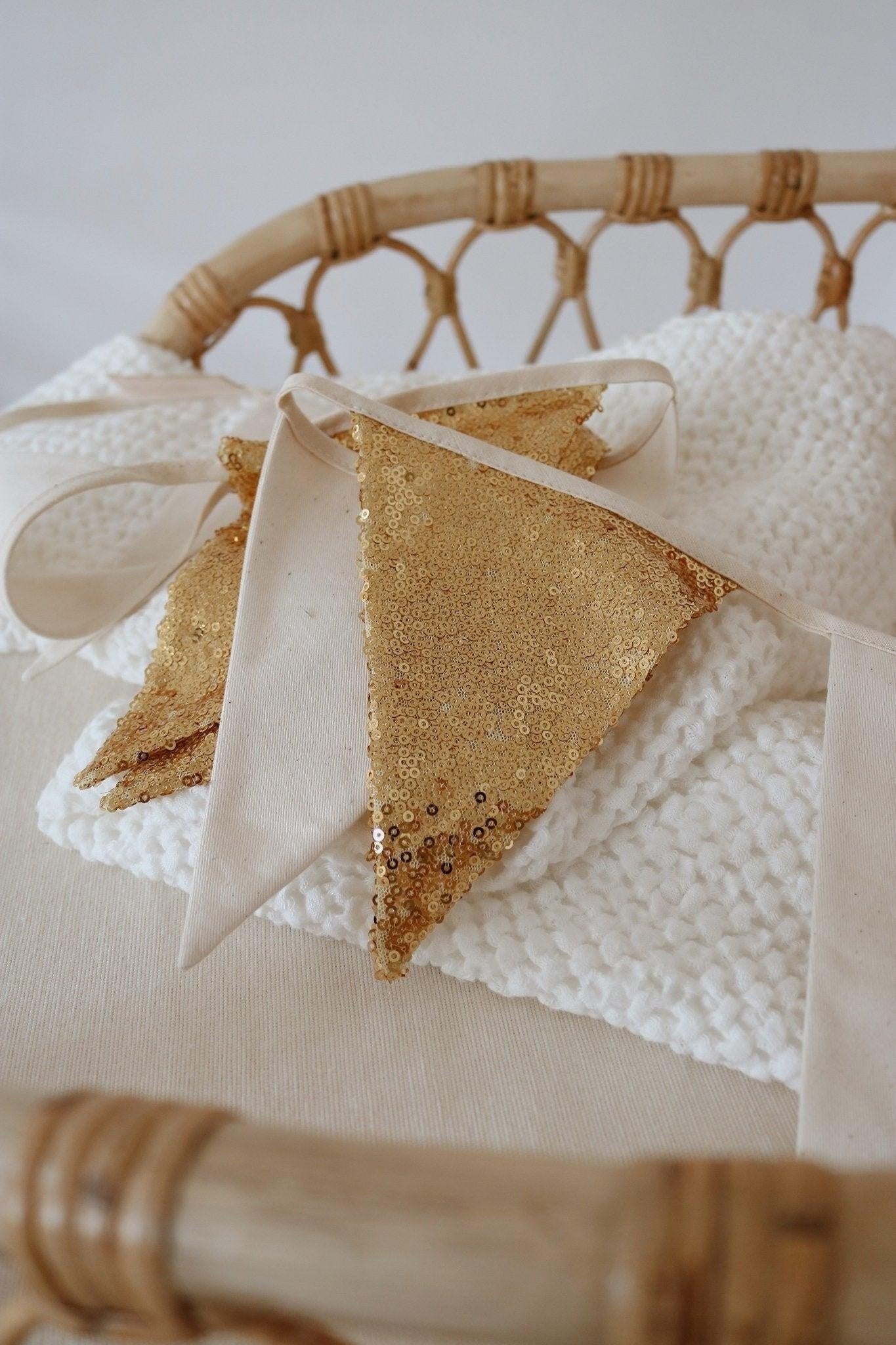 Detailed view of the gold sequins and beige fabric circles on a durable cotton string