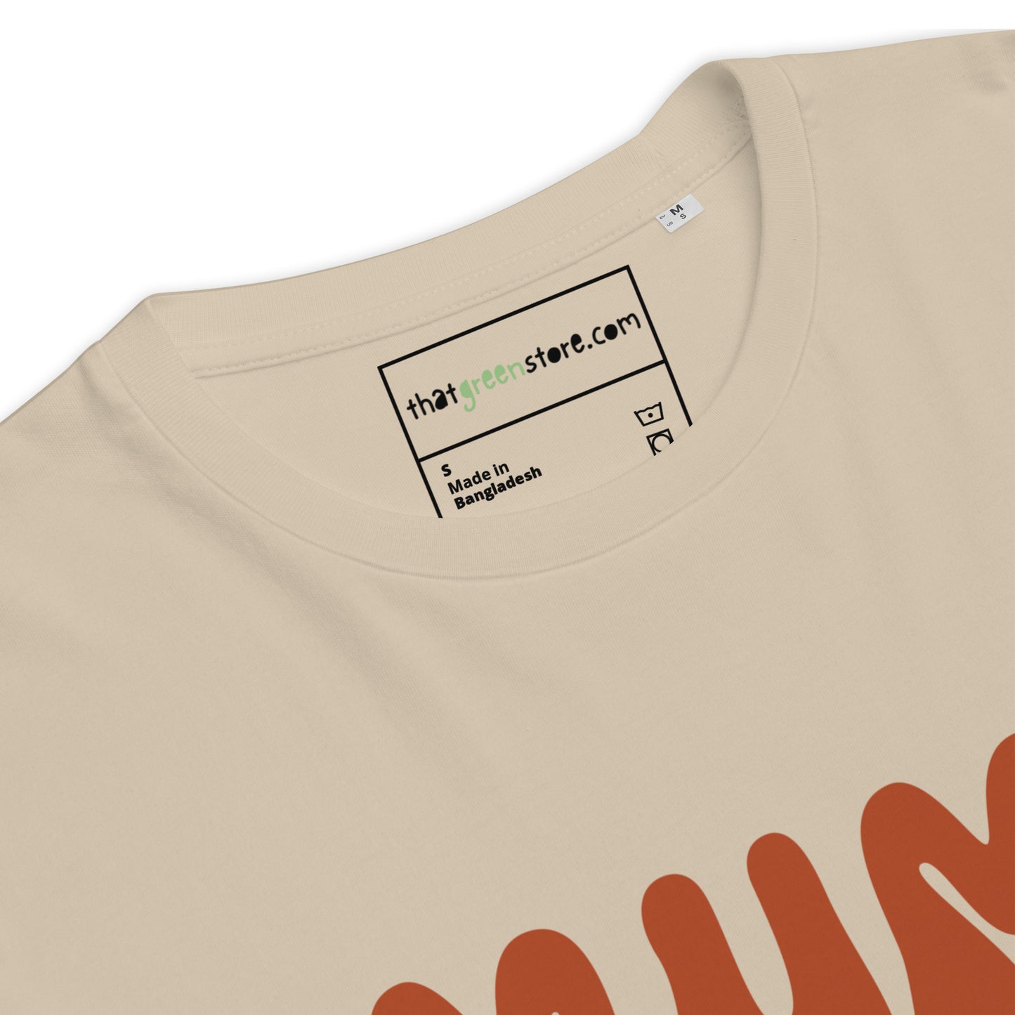 Detail of label of Sand-colored organic cotton t-shirt featuring the quote MUM MODE ACTIVATED in a stacked, retro terracotta font with small stars and a lightning bolt.