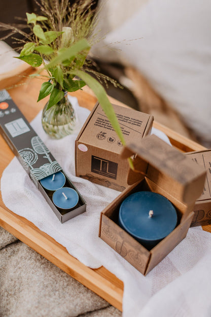 3. Amber scented soy candle burning on a wooden table for a cozy atmosphere