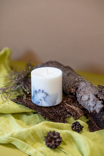 White forest soy candle on a bedside table for a fresh winter scent