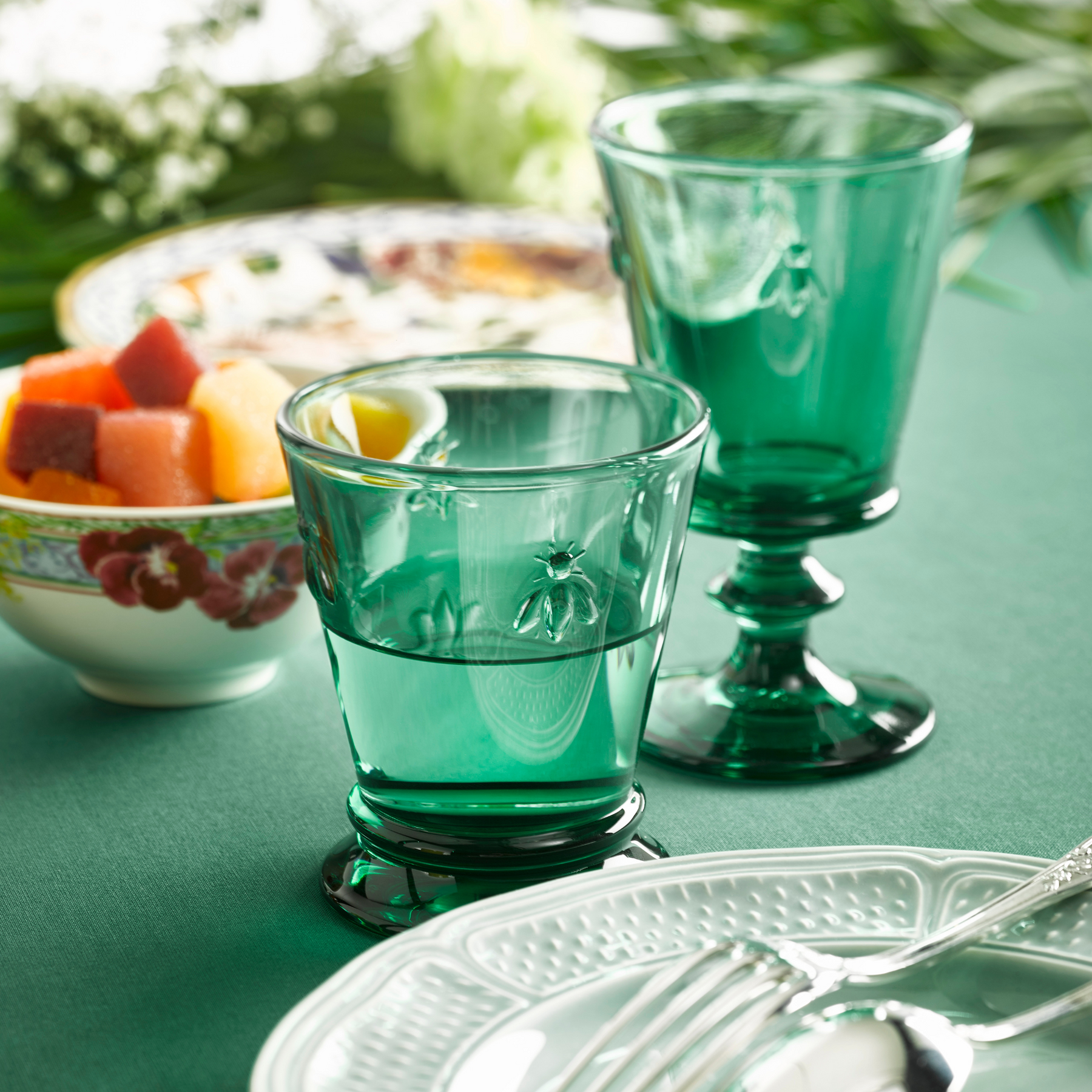 Elegant dining table setting featuring colorful La Rochère Bee water glasses 250ml with fresh linens and tableware