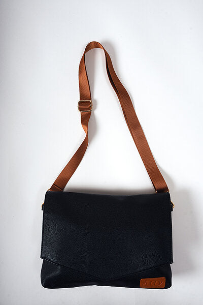 Black Coffee handbag worn as a crossbody bag with the long strap