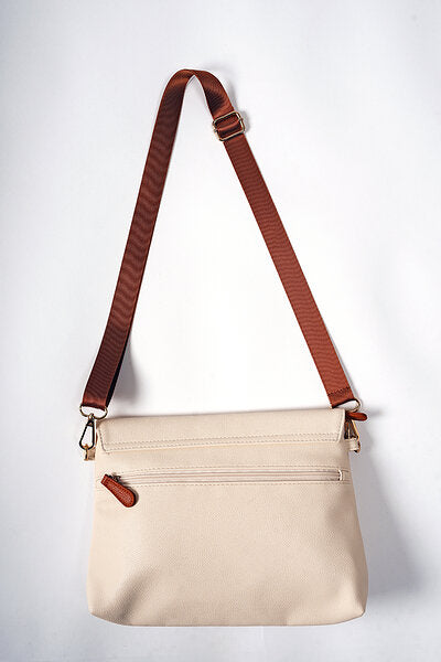 Modern mother wearing the Cappuccino handbag as a stylish crossbody bag