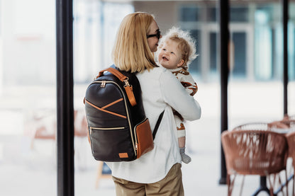 Travel with baby - Large Black Coffee backpack in a transit setting