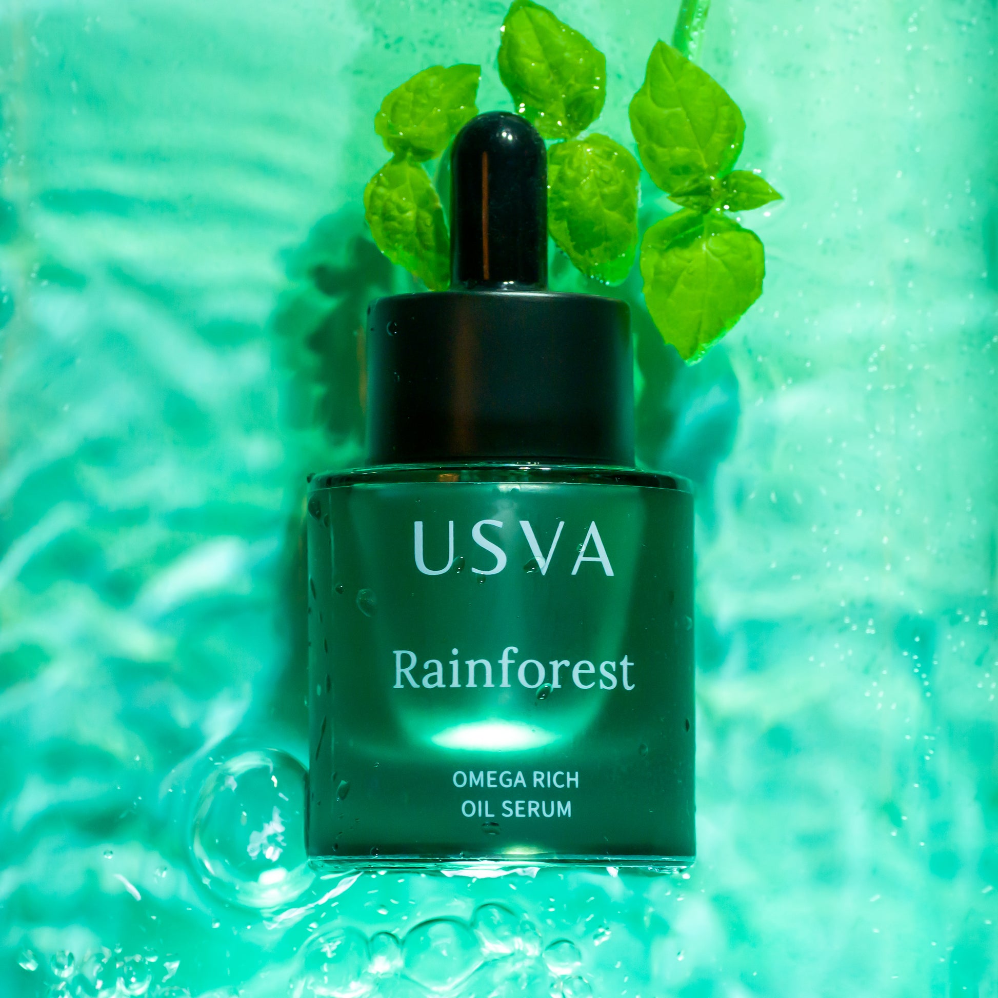 USVA Rainforest Omega Rich Oil Serum bottle with leaves on a green background