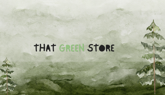 A textured watercolor illustration of misty green hills, framed by two pine trees on the left and right edges. In the center is the brand name "THAT GREEN STORE" in a playful, rustic font, with the word "GREEN" highlighted in a soft, light green and the "O" in "STORE" styled as a solid dark circle.