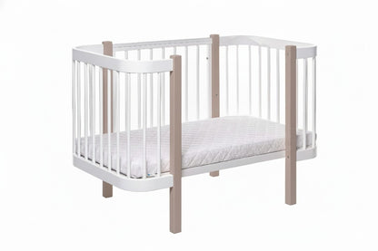 Minimalist nursery room equipped with the Elin cappuccino and white baby crib
