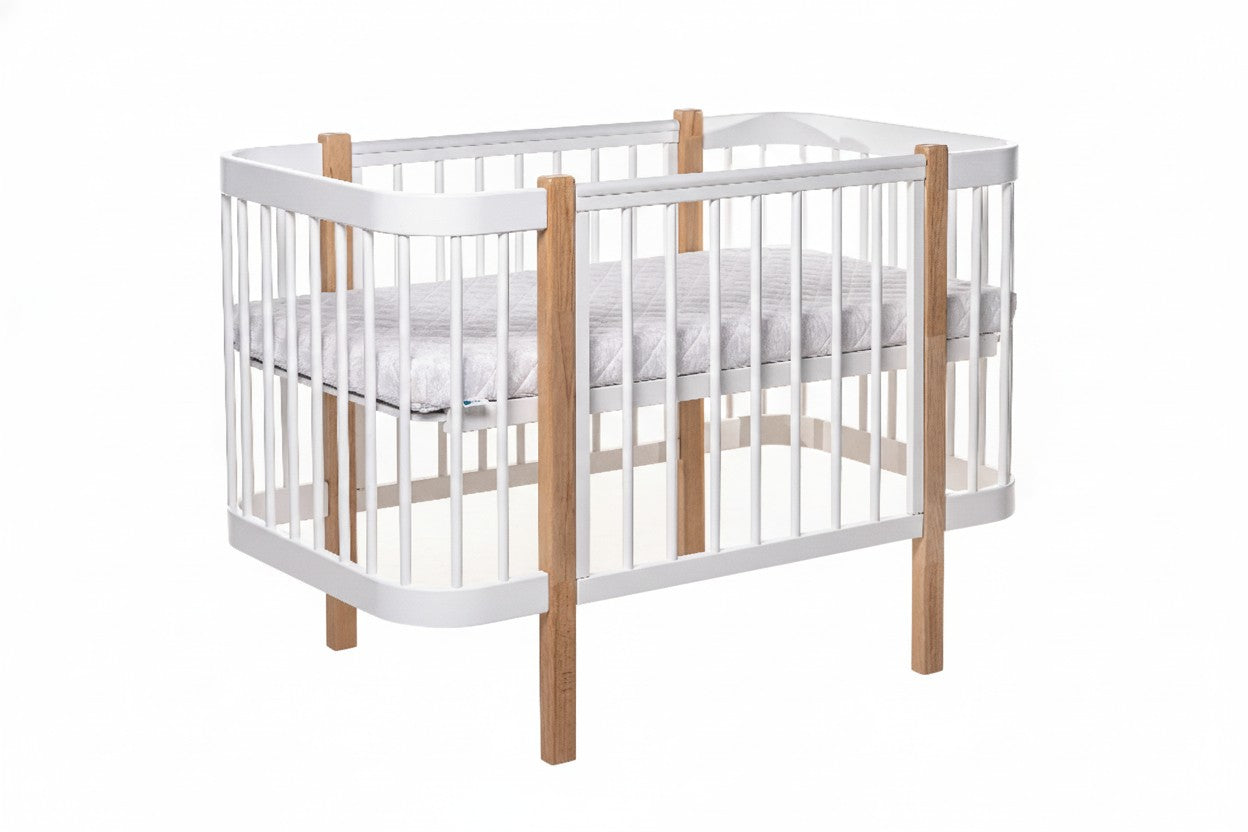 Bright and modern nursery room featuring the Elin natural wood baby crib