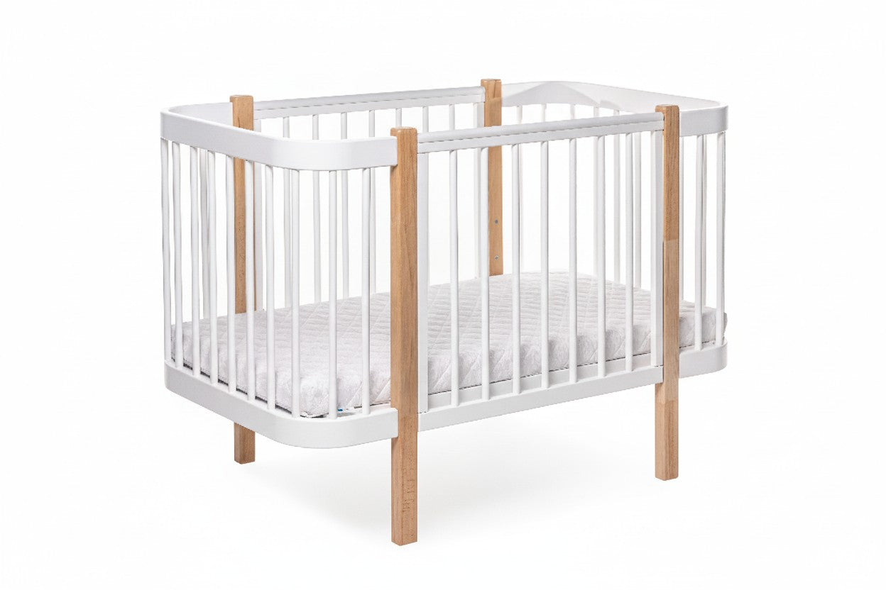 Safe sleep nursery setup featuring a natural wood bed and firm mattress