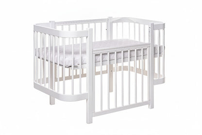 Close-up detail of the non-toxic white paint finish on the KOTTO baby bed