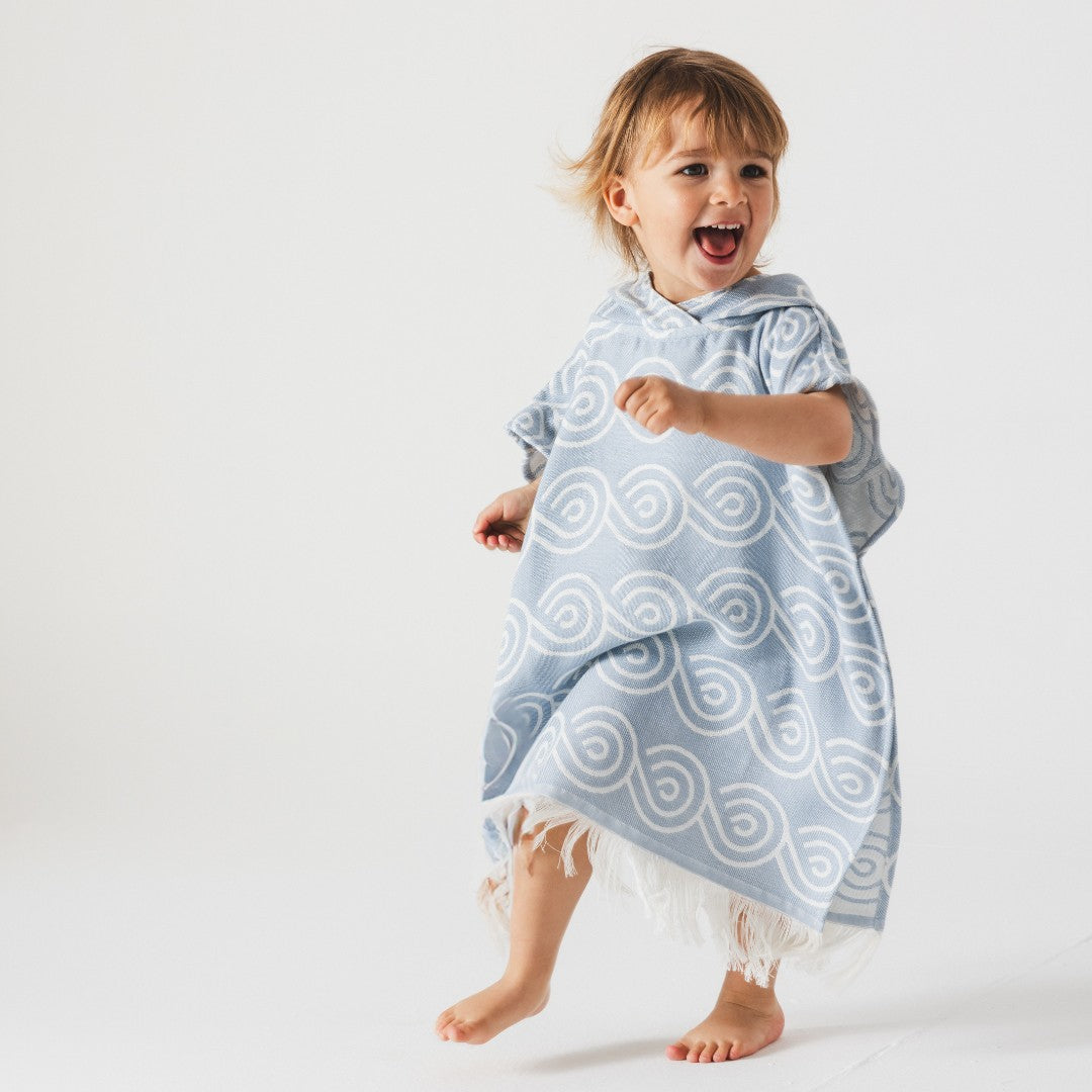 Lifestyle shot: baby wearing bamboo poncho after bath - Light Blue