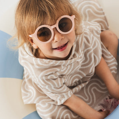 Lifestyle shot: baby wearing bamboo poncho after bath - Sand