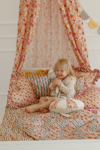Lifestyle: Green Garden small patchwork set styled in a baby bassinet