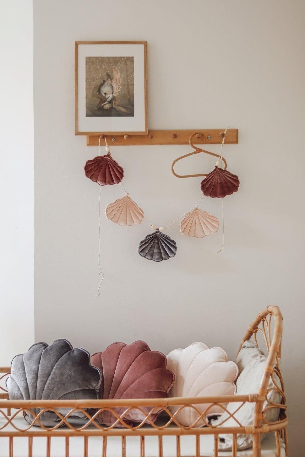 Gender-neutral nursery: Cosmic Pearl shell garland styled with natural wood