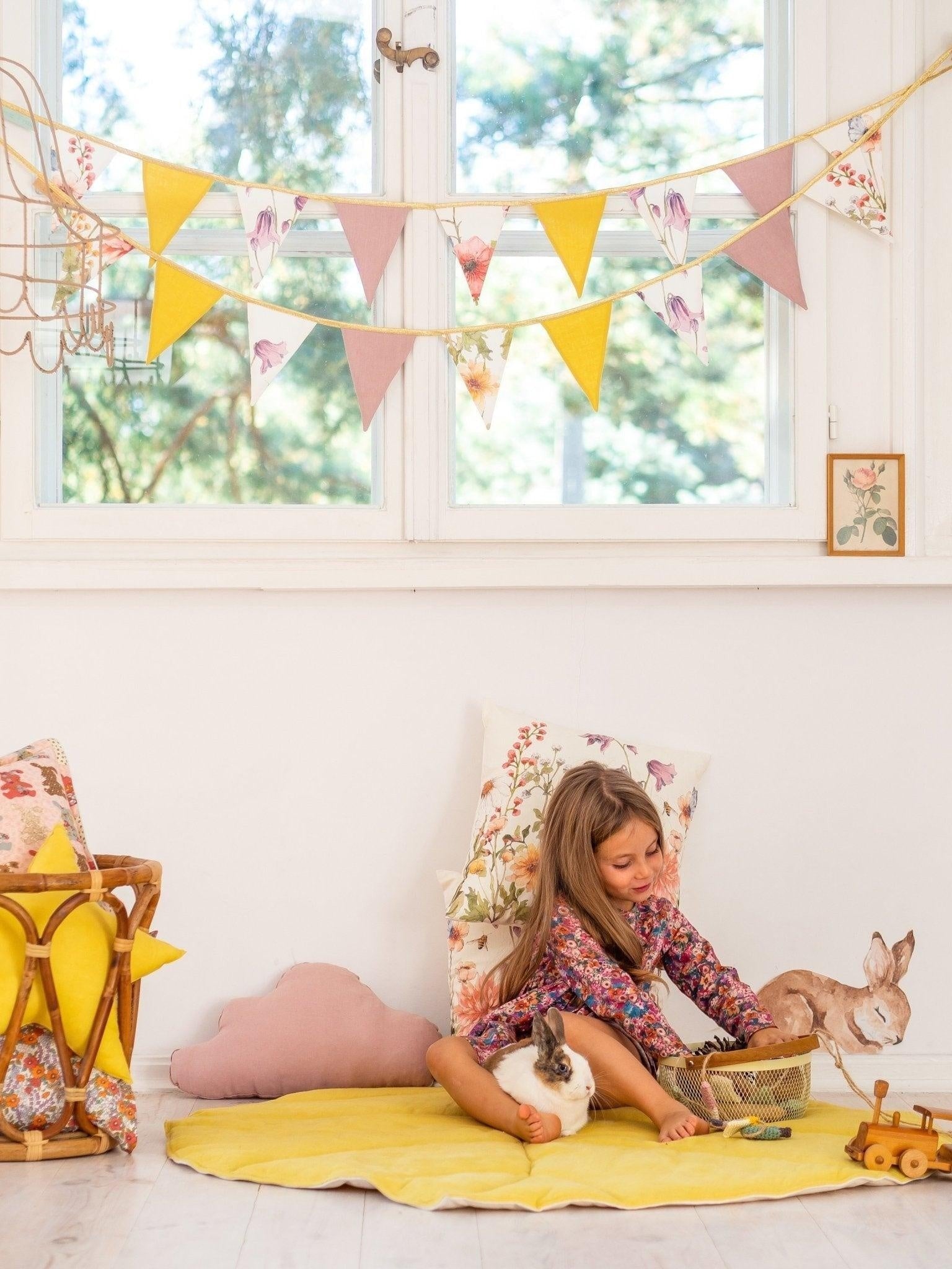 Cosy home scene: Wildflowers linen garland in a sunlit playroom