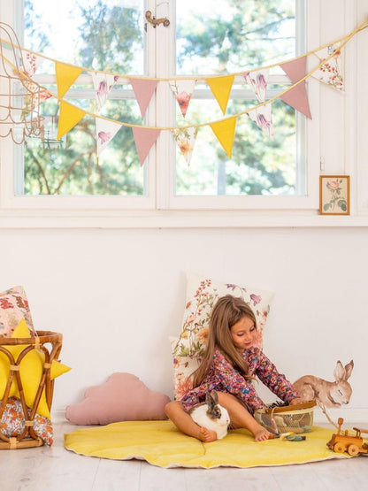 Cosy home scene: Wildflowers linen garland in a sunlit playroom