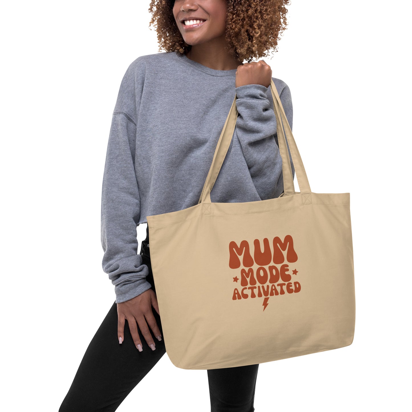 Model carrying the spacious organic cotton tote bag, showcasing its size and long sturdy handles.