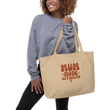 Model carrying the spacious organic cotton tote bag, showcasing its size and long sturdy handles.