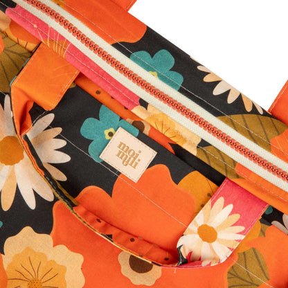 Close-up of the delicate Picnic With Flowers pattern and zips