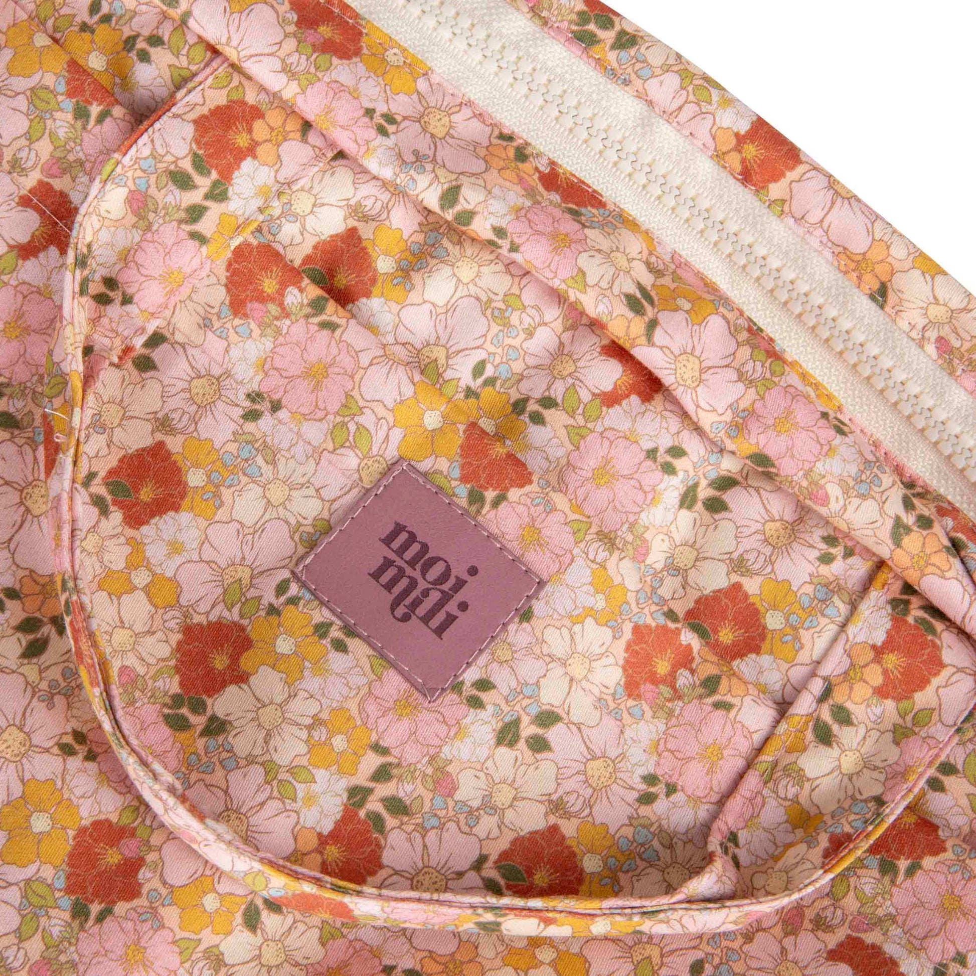 Close-up of the Spring Garden delicate floral fabric and zips
