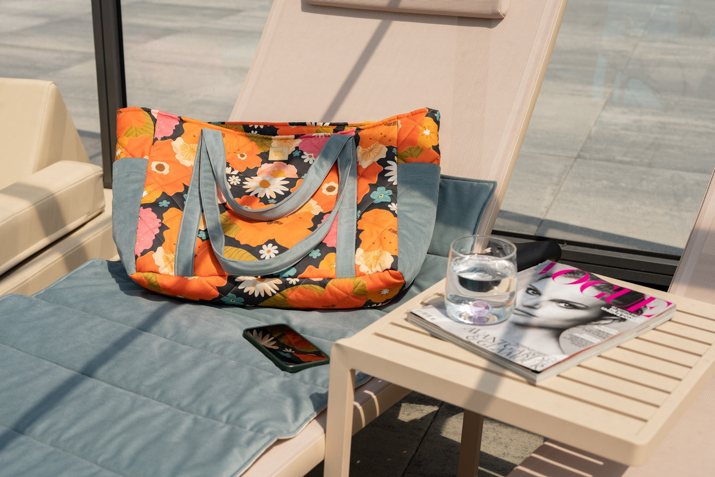 Moi Mili Mom Weekender Bag Picnic With Flowers: large quilted cotton travel bag resting on a poolside sun lounger