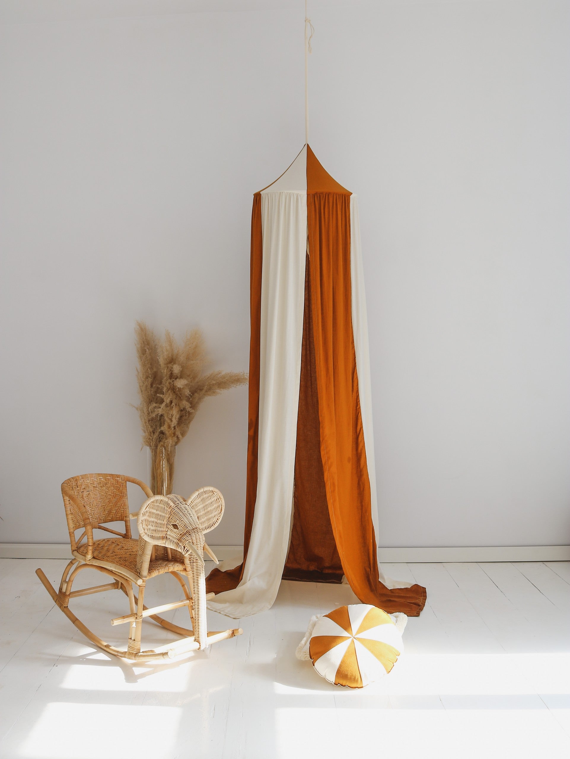 Magic play space: Caramel striped canopy used as a secret hideout in a nursery