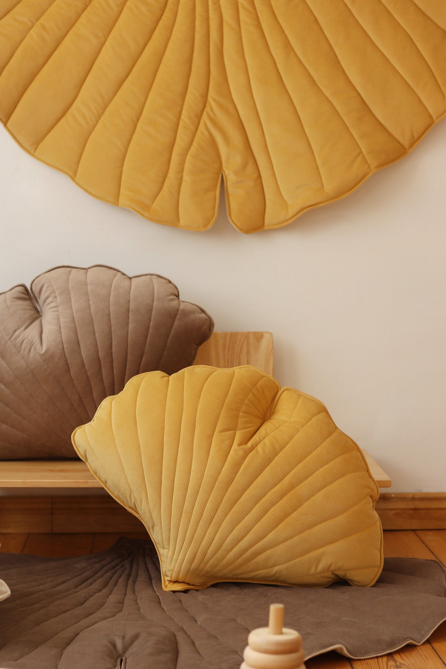 Nursery decor: Yellow velvet ginkgo leaf playmat styled in a bright, modern room