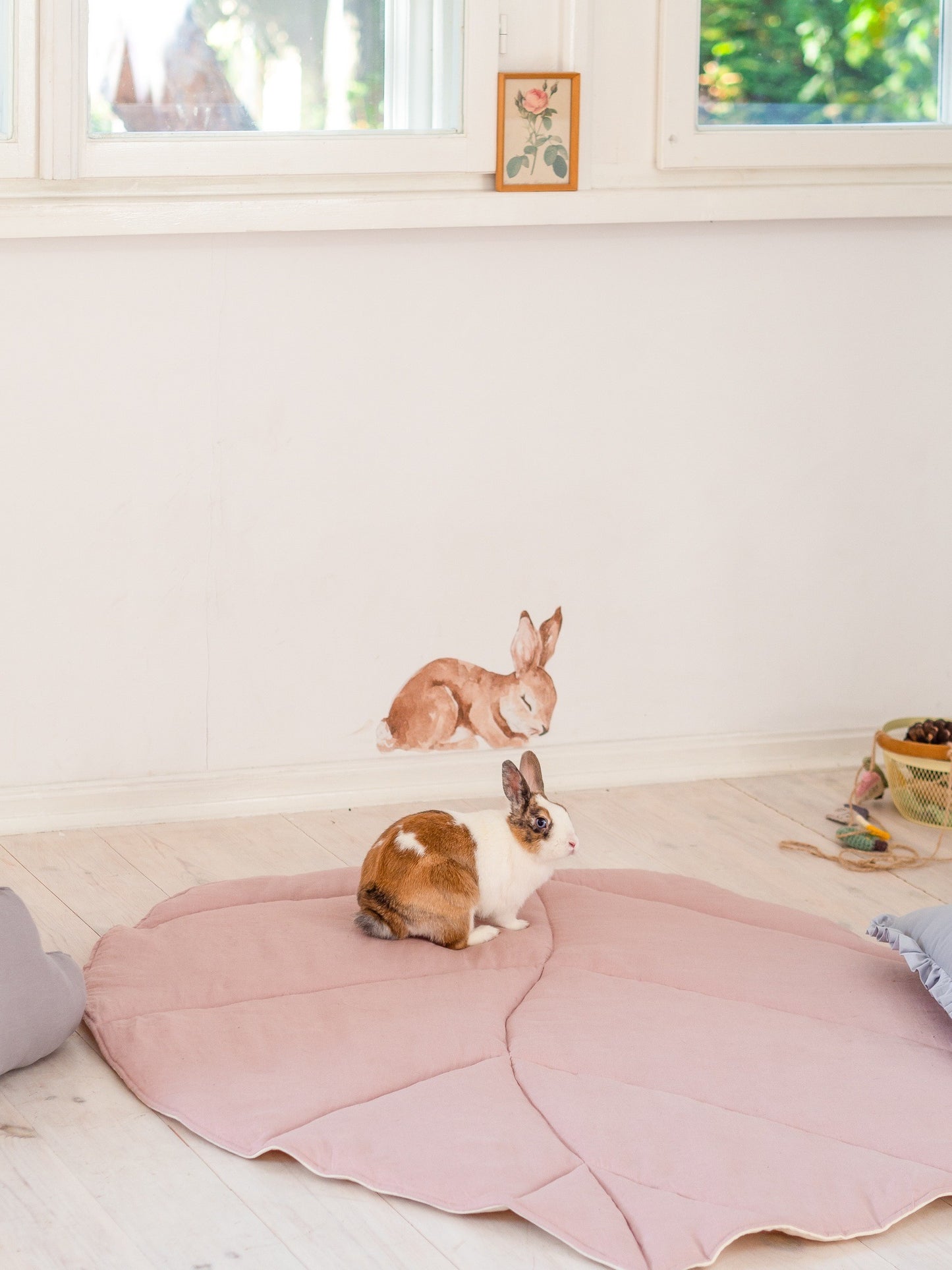 Moi Mili Powder Pink Leaf Playmat: a fluffy bunny rabbit resting on a soft quilted linen leaf-shaped baby mat