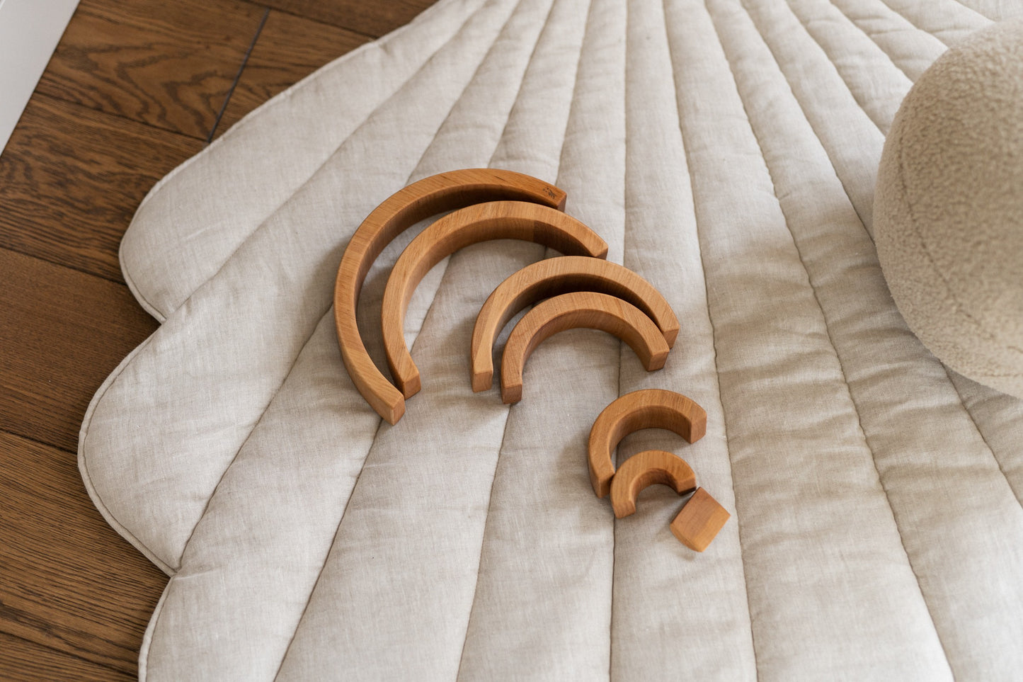 Detailed quilting and stitching on the sand-colored linen shell playmat