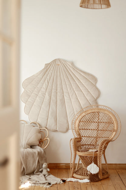 Nursery decor: Beige velvet shell playmat styled in an elegant, neutral room