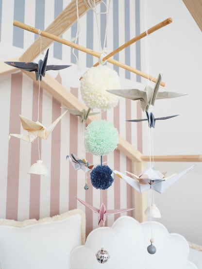 Multi-colored pastel nursery mobile featuring delicate hanging elements and sturdy frame