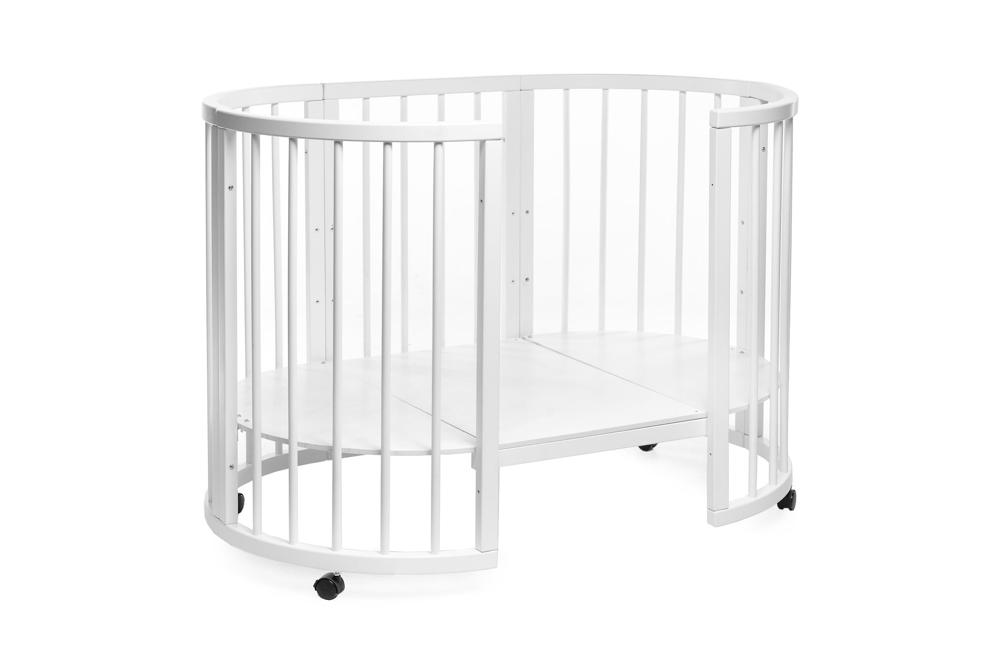KOTTO Olin space-saving round baby crib in a clean white finish with wheels