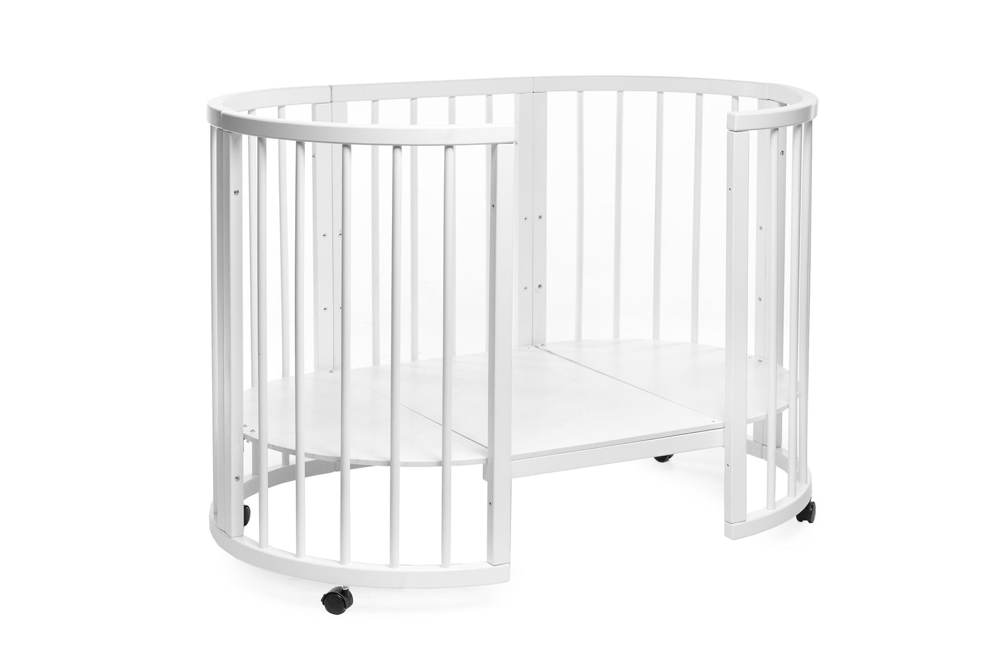 Complete transforming nursery setup featuring the Olin round bed and mattress with wheels