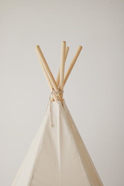 Close-up of the reinforced stitching and natural pine poles of the minimalist beige teepee