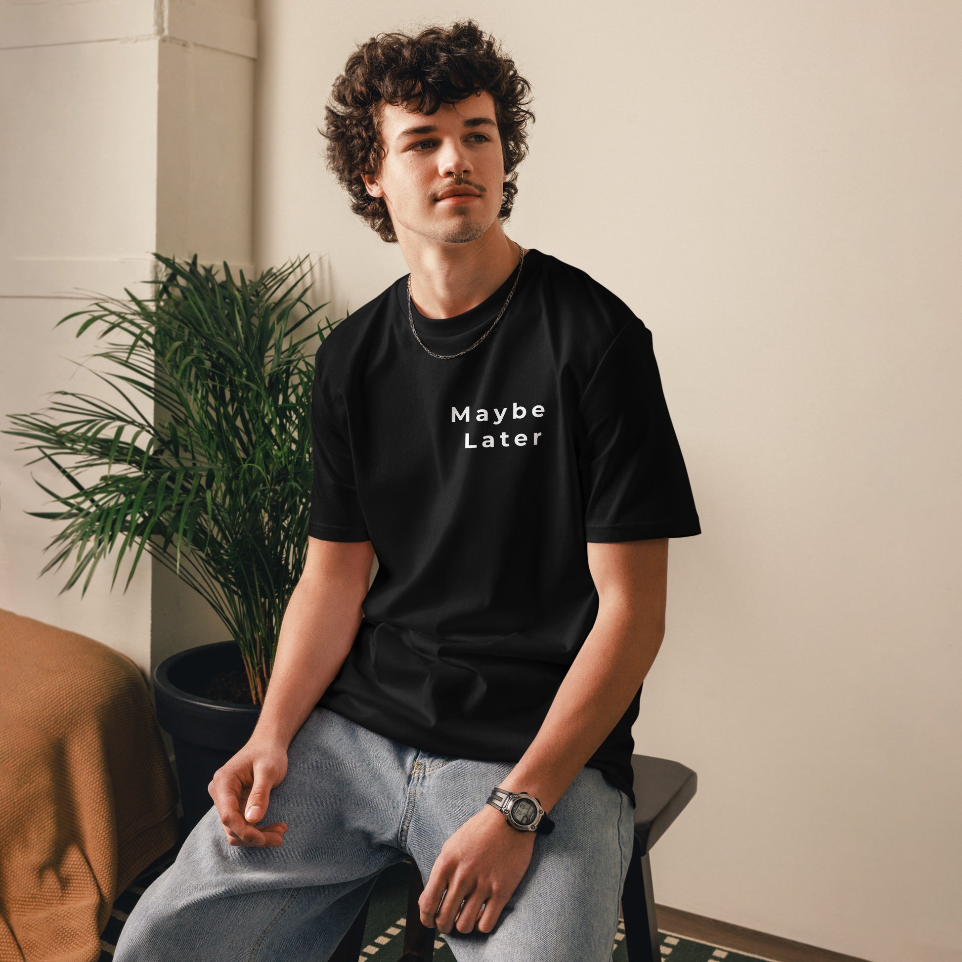 View of a male model wearing the unisex Maybe Later vegan tee. black
