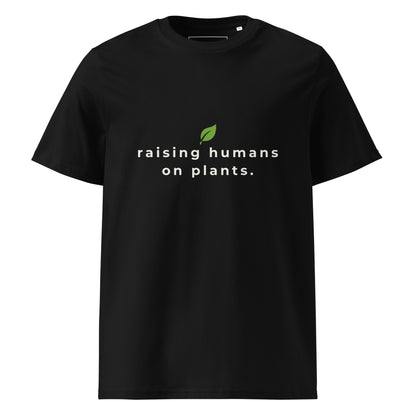 Front flat lay of the "raising humans on plants." black t-shirt, showing the perfect alignment of the text and leaf logo on the chest.
