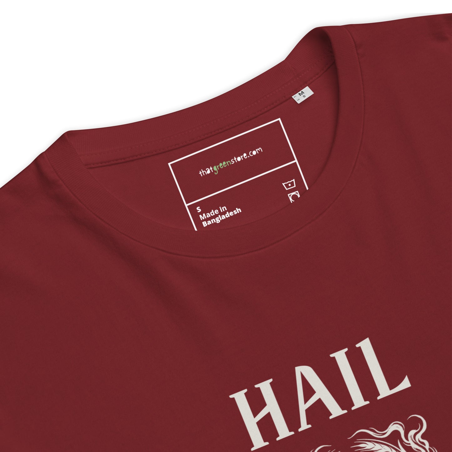 Close-up of the inner neck label on a Burgundy organic cotton t-shirt, showing That Green Store branding above the ivory Hail Seitan graphic.