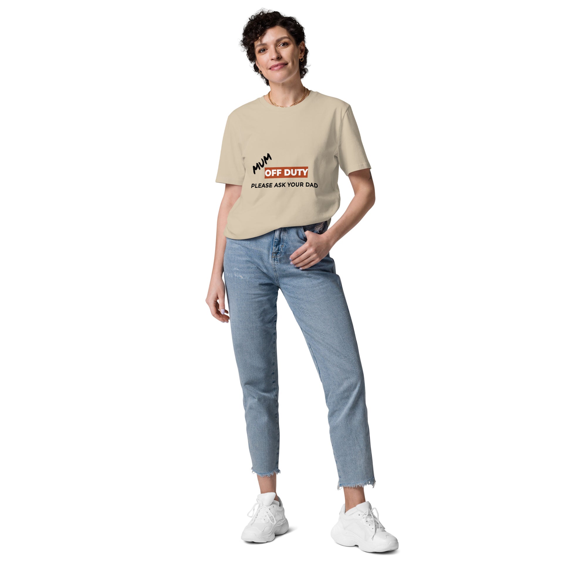 Female model wearing the funny Mum Off Duty organic cotton t-shirt, front view. sand