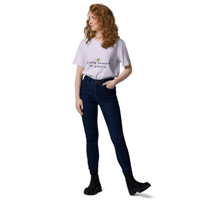 Woman posing casually in a heather lavander organic cotton t-shirt. Featuring the minimalist text "raising humans on plants." with a green leaf logo design.